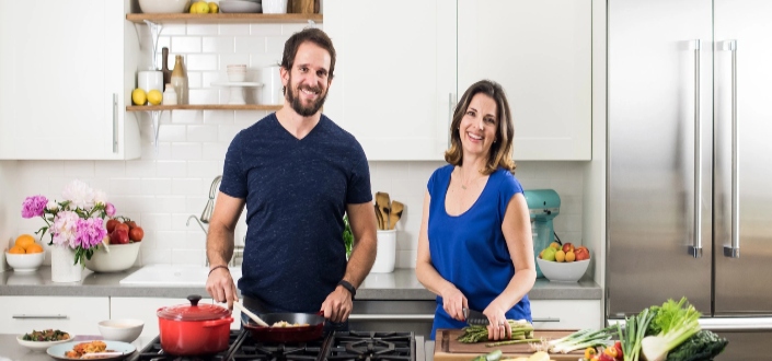 Two people smiling in the kitchen